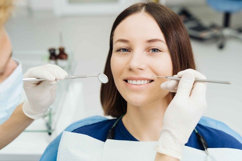 Patient receiving a preventive dental examination during a routine checkup at a dental office